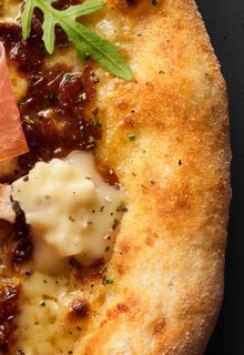 Close up of a prosciutto pizza 